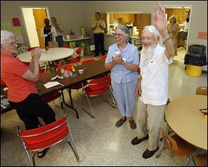 Judy Lee Trautman, next to her husband, Woody, leads the group in 'Happy Birthday.' The Trautmans founded the Multifaith Council in 2003