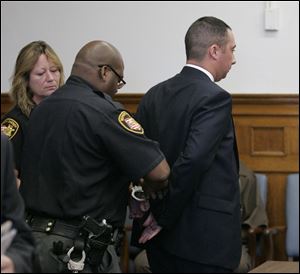 Thomas White is taken into custody after his sentencing. He later posted a $100,000 appllate bond and was released.
