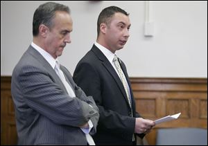 Attorney Jerry Phillips, left, listens as Thomas White defends his actions on the night of the shooting in a statement to the court. Michael McCloskey, Jr., 25, struggles to maintain composure as former Ottawa Hills police officer Thomas White is sentenced in Common Pleas Court. 