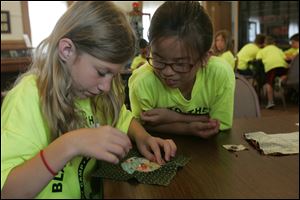 Allison Davis, 8, of Oregon, left, receives encouragement from Alycia Murphy, 9, of Toledo.