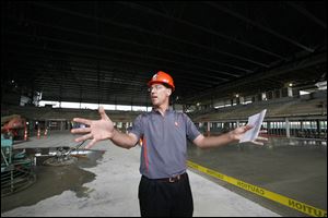 Jim Elsasser, associate athletic director of internal affairs at BGSU, stands on what will be the arena floor of the $36 million Stroh Center, which will replace Anderson Arena.