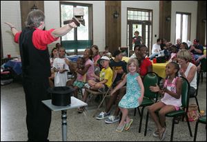 Magician Andrew Martin entertains at the Seventh Annual Yell & Tell: Stop Child Abuse Now rally at Walbridge Park in South Toledo.