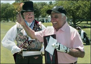 Jamie Farr rings the bell Wednesday after being named an honorary member of the American Guild of Town Criers by Town Crier Michael Lieber of Sylvanina, left.