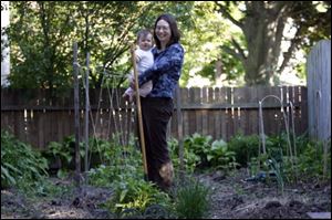 Jennifer Shafer and daughter Chloe in teh garden of tehir home in South Toledo.