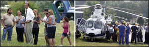 Left, family and friends await news about the conditions of the victims, exchanging hugs and crying. An orthopedic surgeon was on hand as well if Todd Michael, who was trapped, needed his help. 
Right, Mr Michael is shielded from view as he is put in an air ambulance for a trip to Mercy St. Vincent Medical Center in Toledo. 