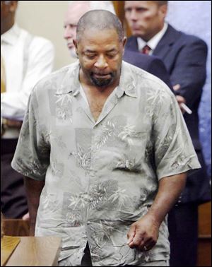 Joseph Jones returns to his seat in court after making a statement on behalf of the late Marland Woods.