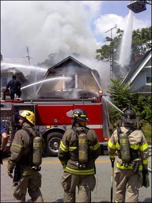 Firefighters battle a blaze at Oak and Navarre in east Toledo.
