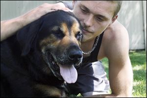 Josh Luck found his dog Tyson bleeding one day. A neighbor and his girlfriend are charged with abducting Tyson and shooting him in the chest and eye on June 23.