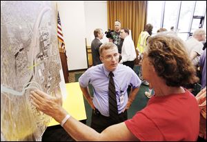 David Dysard, left, ODOT District 2 deputy director, answers a question about speed limits from David Axilrod, a Lincolnshire Woods resident, during the meeting at the Sanger Branch Library.