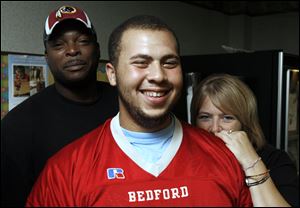 Chris Campbell talks with his parents Shron Gilbert and Tammy Campbell after coming out of a coma at Toledo Hospital.