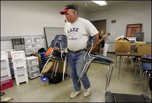 Chemistry teacher Ty Bates sets up a classroom in the Owens Community College building that is to house Lake High School's 400 students until their own building is ready.