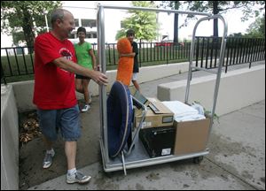 ROV moving    08/11/2010   Blade Photo/Lori King  Monroe, MI residents Scott Kish, Connie Kish and their son, McKinnon, 14, help Paxton Kish, 17, move into his Parks Tower dorm at the University of Toledo in Toledo, OH. School doesn't start at UT until Aug. 23, but Paxton is a member of the drum line and band, whose members move in earlier than most students.