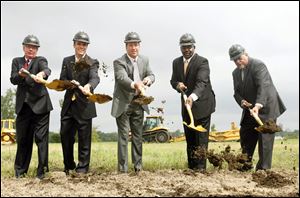 From left, Lucas County Commissioner Pete Gerken, Eric Schippers and Tim Wilmont of Penn National, Mayor Mike Bell and Deputy Mayor Steve Herwat break ground at the Miami Street site of the new Hollywood Casino. 