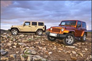 The 2011 Jeep Wrangler Unlimited Sahara, at left, and the Wrangler Sahara.