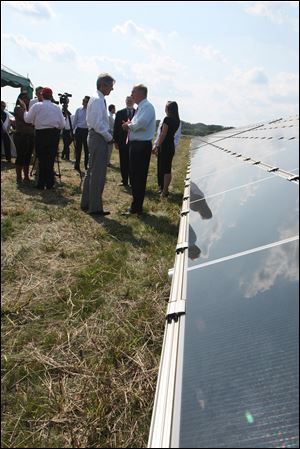 Ralph Izzo, left, chairman, chief executive, and president of Public Service Enterprise Group of Newark, N.J., chats with Ohio Gov. Ted Strickland next to the solar panels during the news conference. The solar farm is owned by a subsidiary of Public Services.