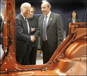 Mr. Biden shakes Jeep complex manager Mauro Pino's hand as they and Chrysler CEO Sergio Marchionne stop by a Wrangler.
