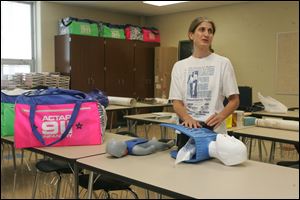 Alice Murray, who teaches health and first aid, unpacks the devices she will use to teach resuscitation techniques.