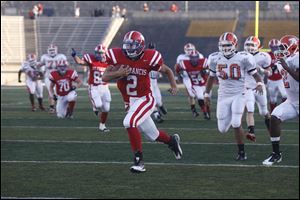 St. Francis quarterback Andy Meinert runs for a touchdown in Friday night's game against Southview at the Glass Bowl. 