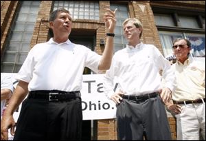 Gubernatorial challenger John Kasich, left, with Lucas County GOP Chairman John Stainbrook, denies Gov. Ted Strickland's claims that the incumbent has whittled away at Mr. Kasich's Republican base.
