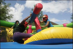Photography student  Maya Jaynes, left, and dental hygiene student Jacqueline Claybrooks battle it out on a joust platform.