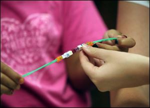 Chloe Curll, 7, of Petersburg, offers an up-close look at her creation. 