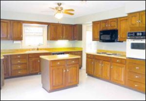 The spacious kitchen is easily the heart of the home, with miles of counter space and a convenient work island.
