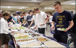 Senior Jimmy Kimerer, right, breaks his fast for Ramadan with classmates at St. John's Jesuit High School in Toledo. The Mediterranean meal was served buffet-style.