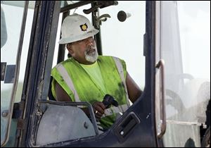 Russell Castillo, operating a backhoe at the State Rt. 24 project, says 2002 was his last year of good income, but work has picked up this season.
