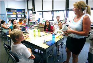 Tammy Garrison, a fifth-grade teacher at Stranahan Elementary in Sylvania Township, talks to her students about an upcoming book they will read.