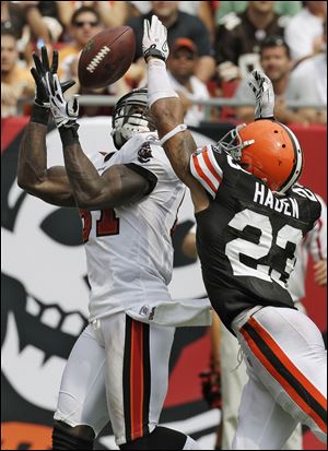 Michael Spurlock of the Buccaneers prepares to pull in the winning touchdown catch in front of the Browns' Joe Haden.