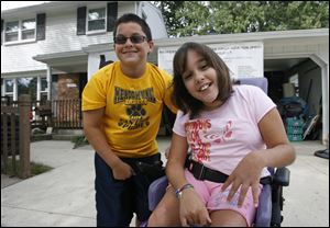 Reyes and Mikayla Garcia, 10, are grateful for the home addition, set to be ready for them to move into Monday. The third triplet is Robert.