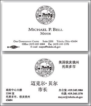 Mayor Mike Bell's double-sided business cards are printed in English on one side and Chinese on the other side
