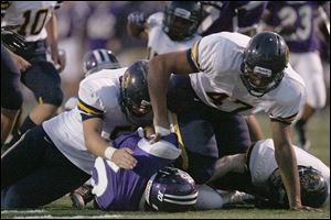 Chris Wormley helps finish a tackle against Fremont Ross. Wormley has 12 tackles including two for losses, six sacks, and has knocked down four passes.