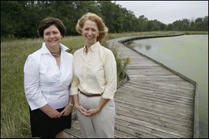 Country Garden Club president Mary Harman, left, and member Virginia Fairhurst Keller are on the boardwalk that the club helped finance at W.W. Knight Nature Preserve in Perrysburg.