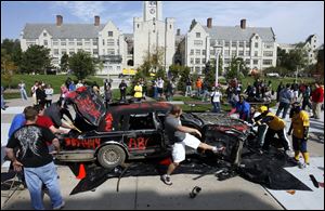 Slug: CTY peprally01p                               9/30/2010 The Blade/Amy E. Voigt                  Toledo, Ohio  CAPTION:  Students smash up a donated Towncar from ABC Auto Parts, during a pep rally at the Student Union to get students and staff excited before the Rockets homecoming game this Saturday against the Wyoming Cowboys.