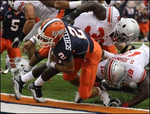 Illinois quarterback Nathan Scheelhaase scores past OSU's Orhian Johnson in Saturday's game.