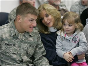 Tech Sgt. Jason Benschoter with his mother, Kathy Benschoter, and niece Julia Poppe, 4, all of Bowling Green, share their happiness during a ceremony honoring him and 21 other ‘hometown heroes' of the 180th Fighter Wing of the Ohio Air National Guard.