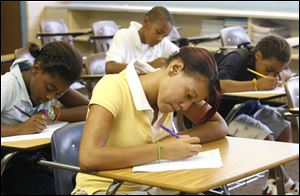 Eighth-grader Shayla Boulton, front, works during a session of Kids Unlimited. Founders say they set up the program because central-city schools lacked quality after-school programs. 
