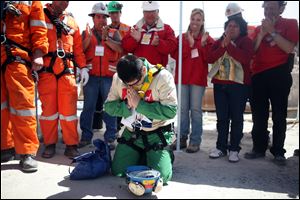 Miner Esteban Rojas, 44, gets to his knees to pray after his rescue. He proposed a church wedding ‘once and for all' in a message to the woman he married in a civil ceremony 25 years ago.
