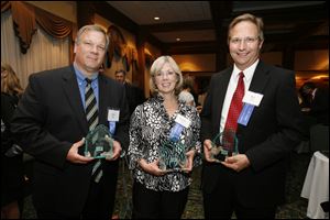 Award winners Gary Yoder, left, Martha Vetter, and Bob Bortel are all smiles after the Touchstone Awards ceremony sponsored by the Toledo Press Club at the Toledo Club. 