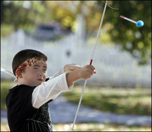 Dylan Logan, 9, of Maumee learns how to shoot a soft-tipped arrow. 