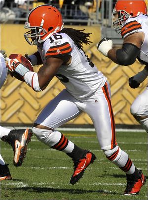 Joshua Cribbs looks for yardage against the Steelers on Sunday in the first quarter. He was knocked out in the second quarter on a hit from linebacker James Harrison.