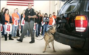 Fulton County sheriff's Deputy John Trejo gives commands to canine partner Dante, who is searching for contraband drugs during a demonstration.