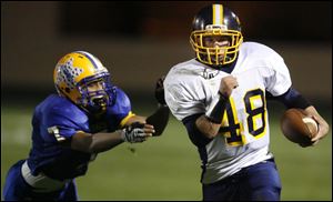 Toledo Christian's Graham Miller pulls away from Northwood's Daniel Prothero.