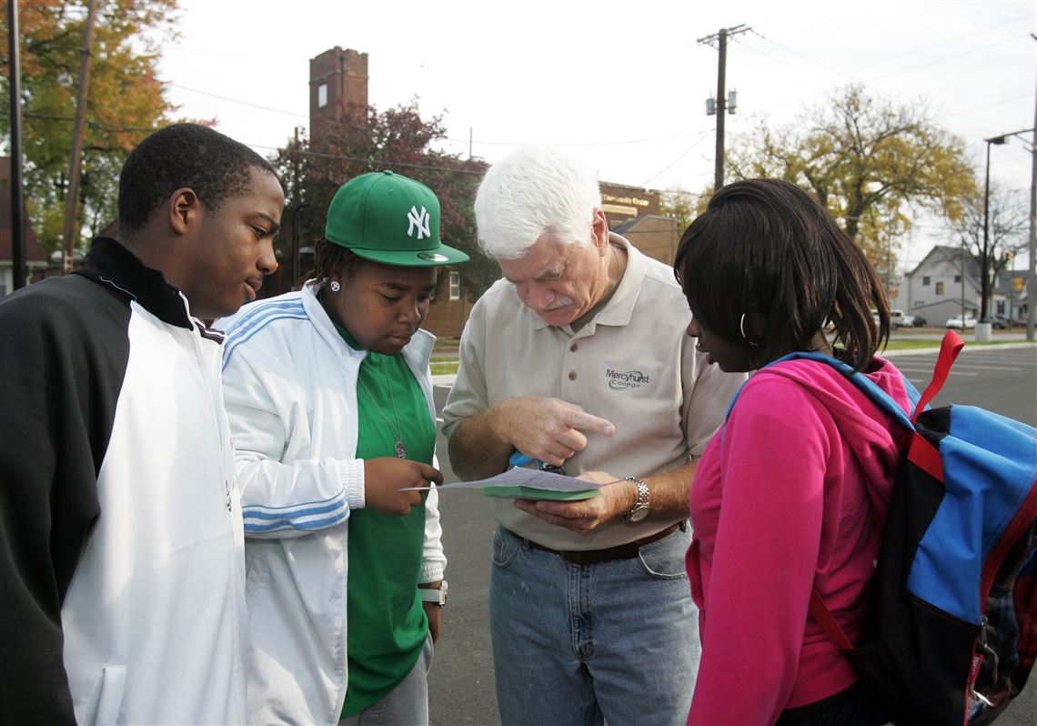 REG tpsvote23p Woodward HighSchool junior Katawun (cq) Green, 17, left, his sister senior Kennesha (cq) Green, 17, [She will be 18 on Wednesday, October 27, 2010], superintendent James Pecko, and Woodward High School junior Shakiya (cq) Simmons, 16 study the map to determine the streets they are going to leaflet. Toledo Public Schools superintendent James Pecko, joins Wooward High School students, staff, and faculty as they leaflet neighborhood schools as part of a 