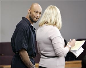 Steve A. James watches as his attorney, Jane Roman, tallies his sentence Tuesday. He was convicted of the attempted holdup of Allied Music on South Byrne.