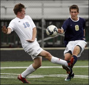 Ryan Peterson, right, a senior, battles Bowsher's Max Klinksiek. Peterson has 21 goals and 14 assists. The Titans are 17-1-0. 