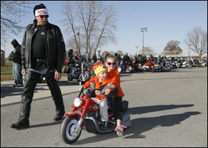CTY toyrun08p  Grandfather Bill Daniels, of Temperance, Michigan, with his grandchildren Herbie, 4, and Shayla (cq) Haynes (cq), 7, both of Toledo, cruising. Santa Claus, Michael Wenzel (cq), of Toledo, founder and organizer of the 21st Annual Bikers of N.W. Ohio Toy Run, and Toledo Mayor Mike Bell lead about 1500 riders from the Toledo Speedway inToledo to the Lucas County Recreation Center in Maumee, Ohio on a benefit ride for children of Harbor. The ride was escorted by Lucas County Sheriff Department motorcycle officers who donated their time for the benefit. 