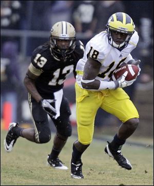 Michigan cornerback James Rogers intercepts a pass intended for Antavian Edison.