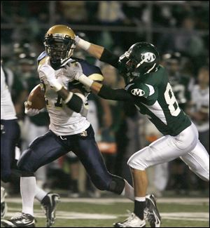 Nate White of St. John's tries to escape the grasp of Medina's Cameron Hynes.